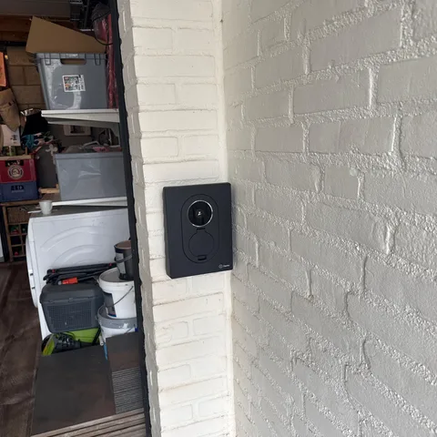 Zwart Zaptec laadpunt naast de garagedeur van een woning in Ede