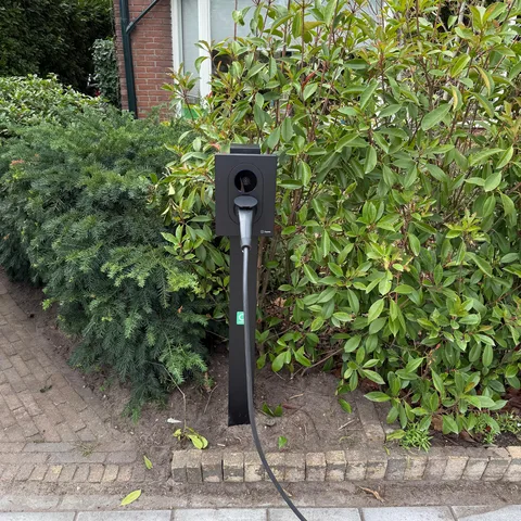 Zaptec laadpaal op een paal in de voortuin van een woning in Houten